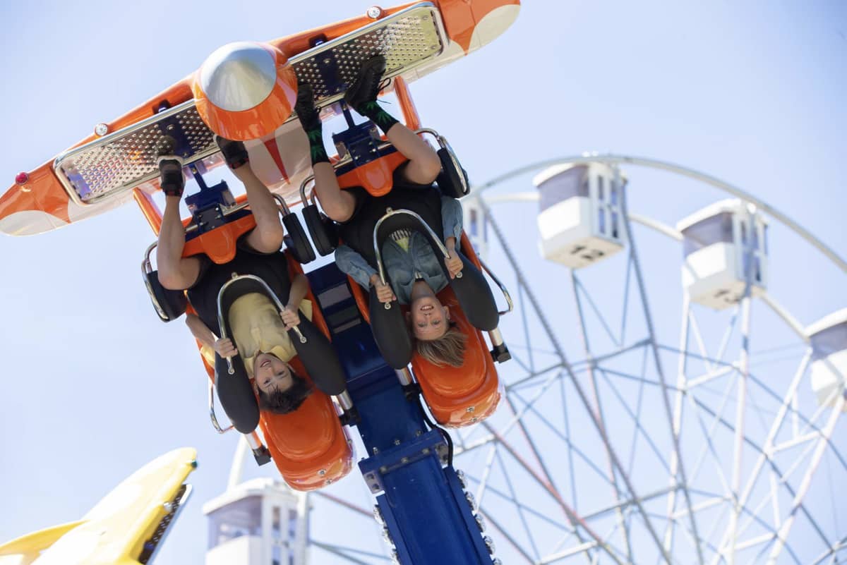 People on an upside down roller coaster